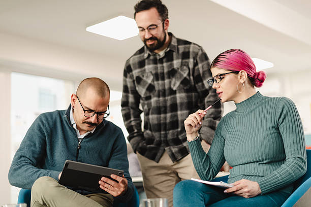 istock Business professionals collaborating on a project while discussing ideas in a modern office space during the late morning hours 2241591049