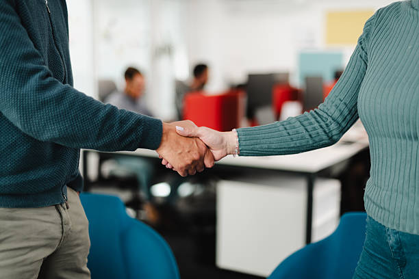 istock Business meeting between colleagues with handshake in modern office setting during daytime 2241591122