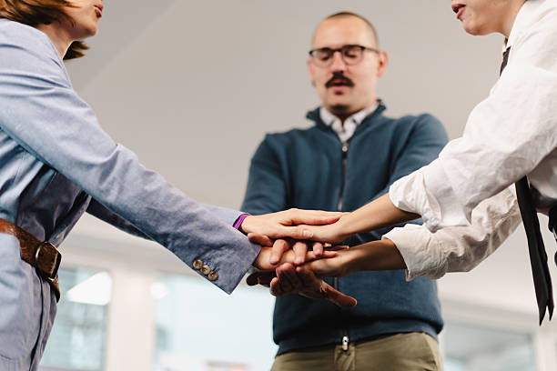 istock Business professionals engage in teamwork exercise to build collaboration skills during a workshop in a modern office setting 2241591232