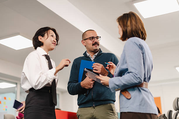 istock Businesspeople collaborate in a modern office setting while discussing ideas and sharing documents during a team meeting 2241591273