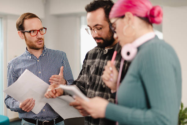 istock Business professionals collaborate in modern workspace discussing project details and reviewing documents during afternoon meeting 2241591368