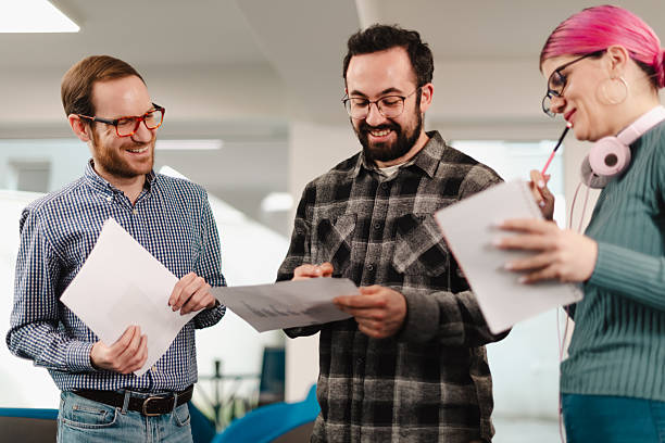 istock Business team collaborates in modern office space discussing project details and sharing ideas during a productive meeting 2241591380