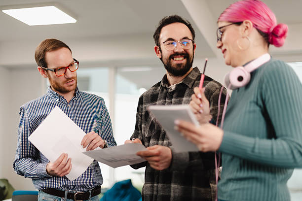 istock Businesspeople collaborating in a modern workspace during a team meeting with documents and notes 2241591384