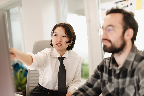 istock Business professionals collaborate in a modern office space during a meeting, discussing ideas and strategies with a focus on productivity and teamwork 2241591425
