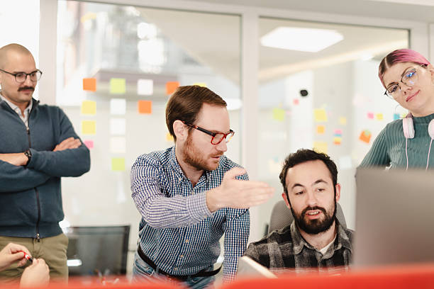 istock Business professionals collaborating in a modern office space during a work meeting 2241591459