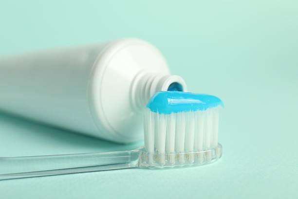 istock Toothbrush with toothpaste and tube on light blue background, closeup 2241592861