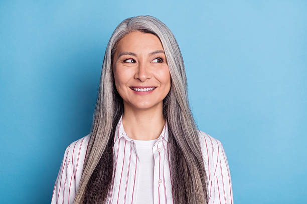 istock Portrait of attractive curious cheerful grey-haired woman creating solution isolated over bright blue color background 2241593917