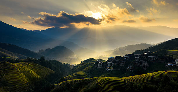 istock Sunset Rays Over Terraced Fields and Mountain Village 2241594238