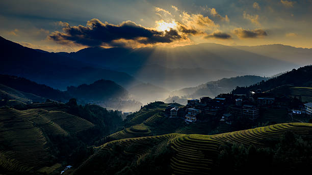 istock Sunset Rays Over Terraced Fields and Mountain Village 2241594310