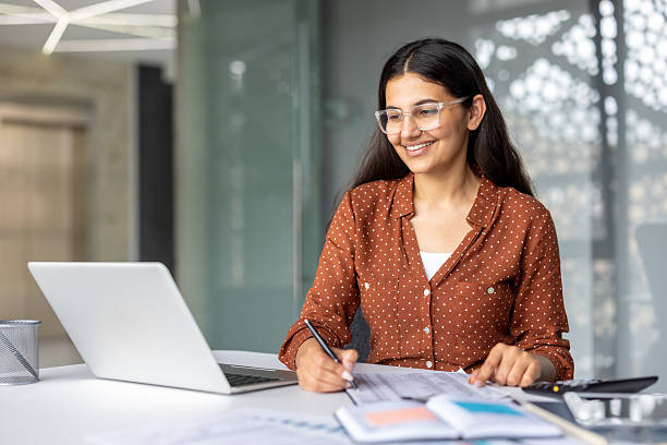 istock Indian businesswoman working laptop, writing notes in office 2241595388