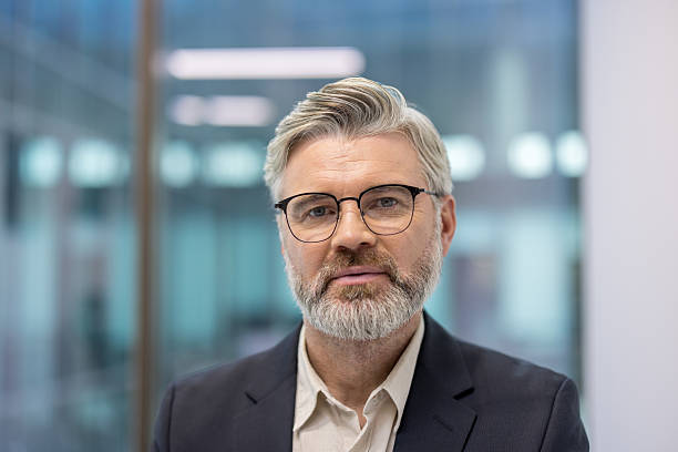 istock Senior businessman portrait standing in modern office 2241595988