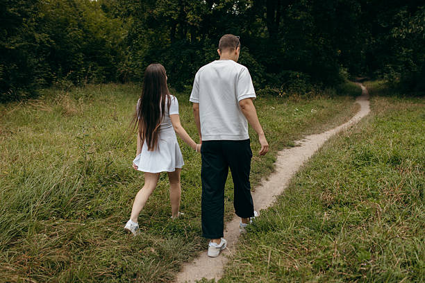 istock Young couple walking at nature at summer 2241598474