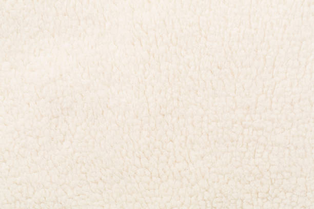 istock White cuddle teddy bear fabric as background, top view 2241598988