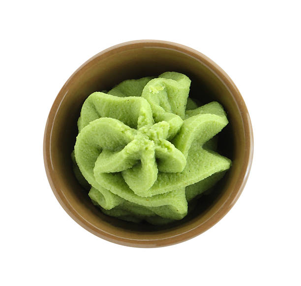 istock Hot wasabi paste in bowl isolated on white, top view 2241608032