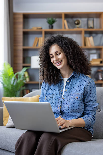 istock Woman working remotely on laptop at home 2241610892
