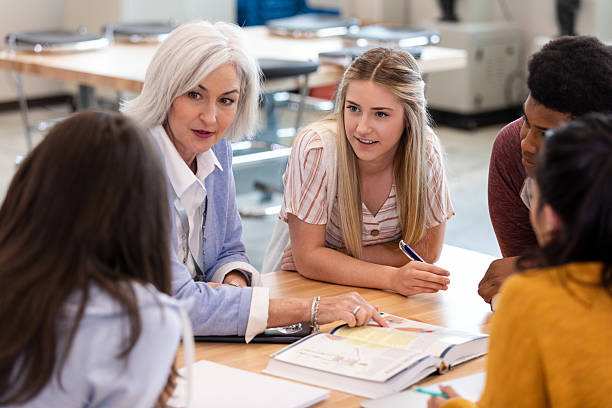 istock Diverse group of students and teacher collaborating on a project in a classroom setting. 2241611480