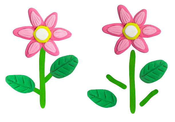 istock Colorful handmade clay flowers crafted with plasticine, featuring bright pink petals, yellow centers, and green leaves. A cheerful and creative design perfect for art projects, education, crafts, and playful decoration. 2241611484