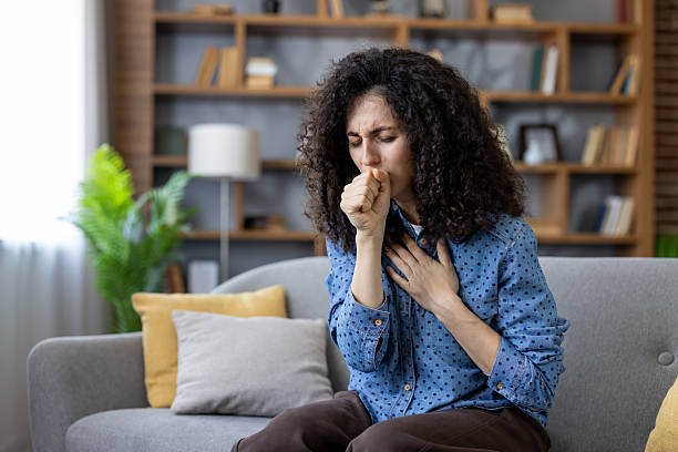 istock Sick woman coughing at home on sofa, suffering from cold or flu virus 2241611498