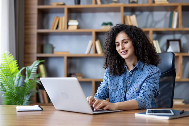 istock Woman working on laptop achieving remote productivity 2241613459