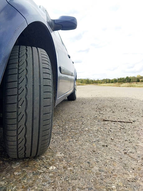 istock Car parked on a gravel road under a cloudy sky 2241614357
