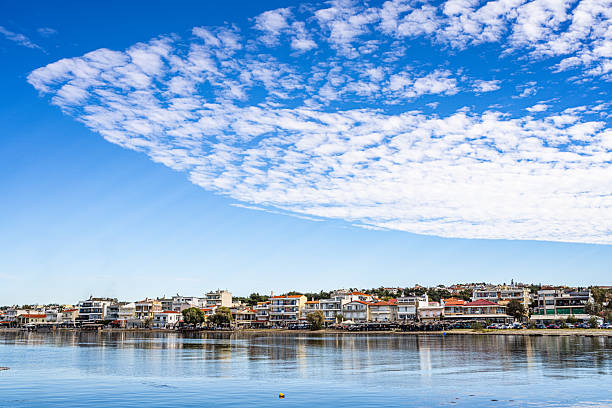 istock Coastal Town Neoi Epivates Reflected in Calm Water under Blue Sky with Cloud Patterns in Northern Greece. 2241618518