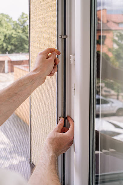 istock Repairman installing a new PVC window frame in a residential setting 2241625580