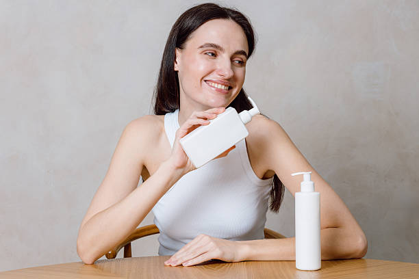 istock Young woman exploring skincare options in a relaxing home environment 2241625689