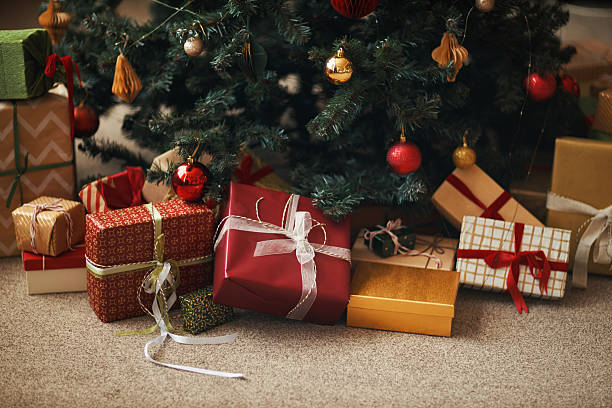 istock Christmas Gifts Arranged under Tree Awaiting Celebration and Family Gathering 2241626193