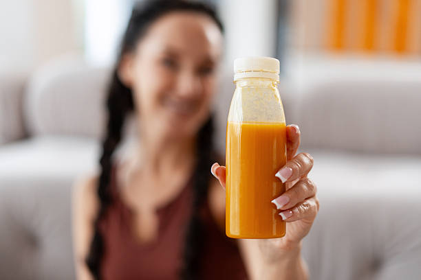 istock Woman holding refreshing detox juice bottle 2241629247