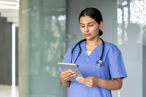 istock Nurse holding tablet working in hospital hallway 2241629611
