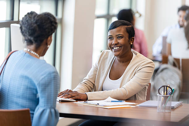istock Two women engaged in a positive discussion in an office setting. 2241629976
