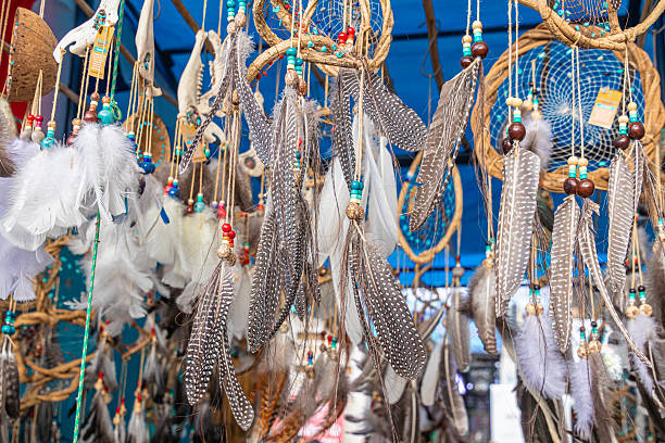 Colorful dreamcatchers made with bird feathers are sold at the weekly Plaza de los Ponchos market in Otavalo, Ecuador