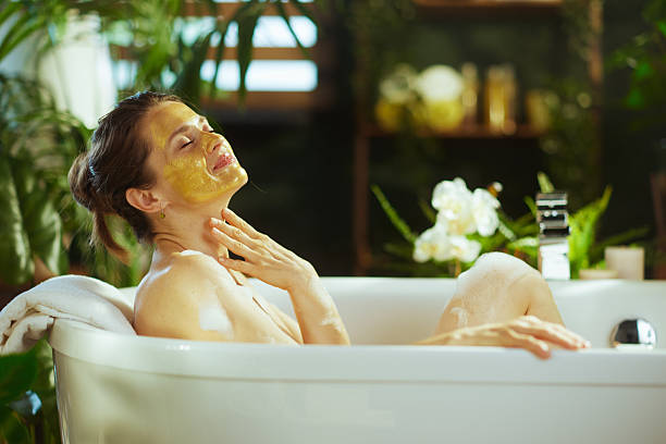 istock Peaceful Bathtub Retreat with Yellow Mask 2241635085