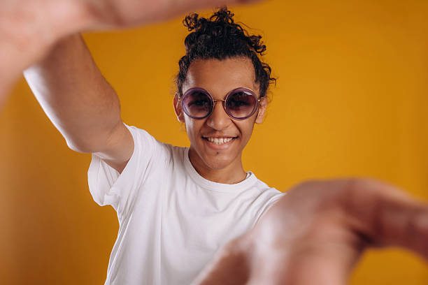 istock Selfie time, posing. Young guy is against yellow background 2241639359