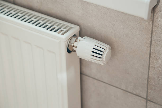 istock White heating radiator with thermostatic temperature regulator. Heating season. Energy saving 2241640657
