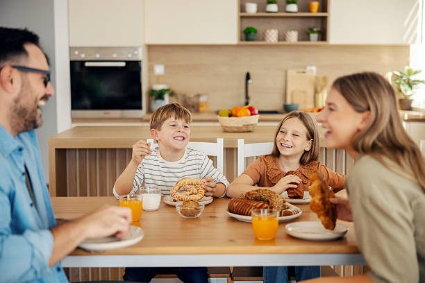 istock Family enjoying happy breakfast at home kitchen table 2241641201
