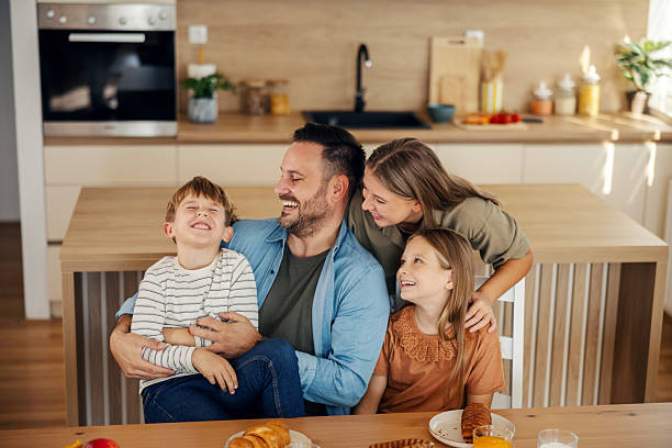 istock Happy family enjoying breakfast in modern kitchen 2241641452
