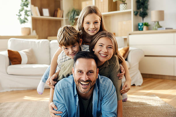 istock Happy family stacking on dad showing unity and love 2241641767