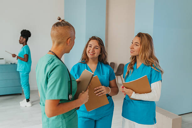 istock Healthcare workers collaborating in a modern clinic, sharing ideas and building teamwork for patient care and support 2241644827