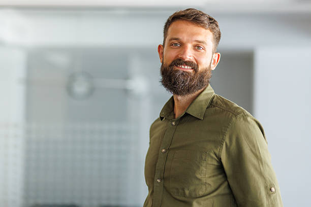 istock Bearded man smiling in smart casual office attire 2241647129