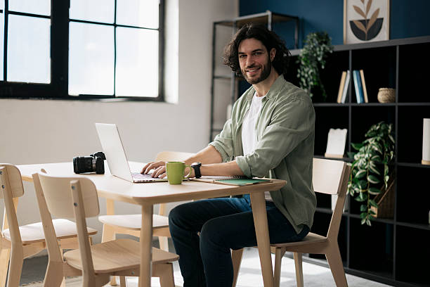 istock Portrait of young man working from home using laptop 2241647218