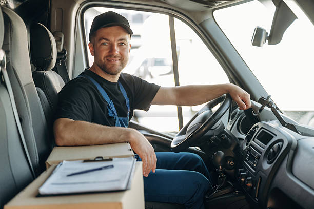 istock Document lying down on the box. Inside of the bus with delivery service man in uniform 2241648051