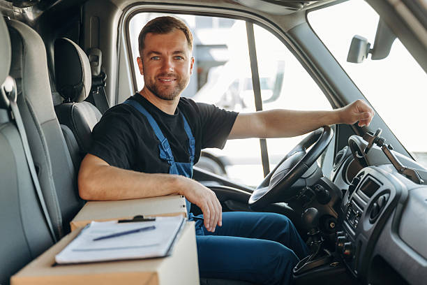 istock Document lying down on the box. Inside of the bus with delivery service man in uniform 2241648076