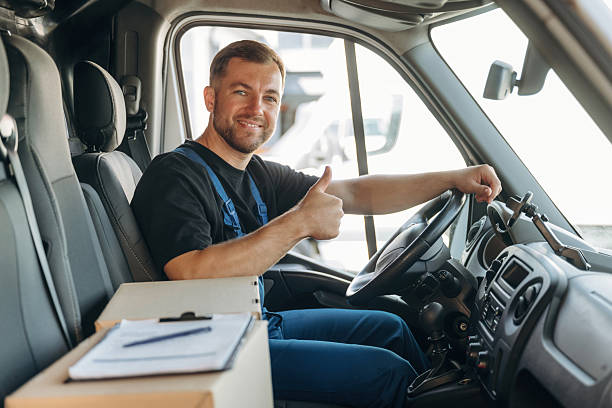 istock Document lying down on the box. Inside of the bus with delivery service man in uniform 2241648085