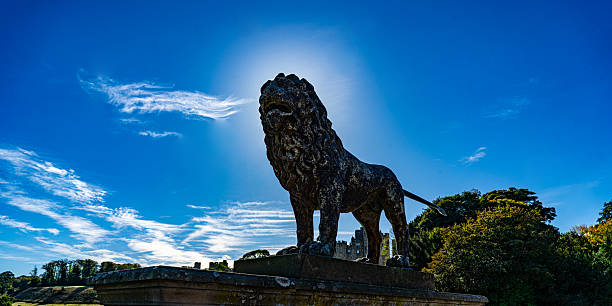 Madrid, Spain - July 30 2018: Statue of a bronze lion, part of the monument to Alfonso XII in the Buen Retiro Park in Madrid, Spain.