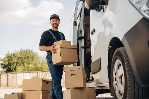 istock Guy courier is near the van, holding the packages 2241649724