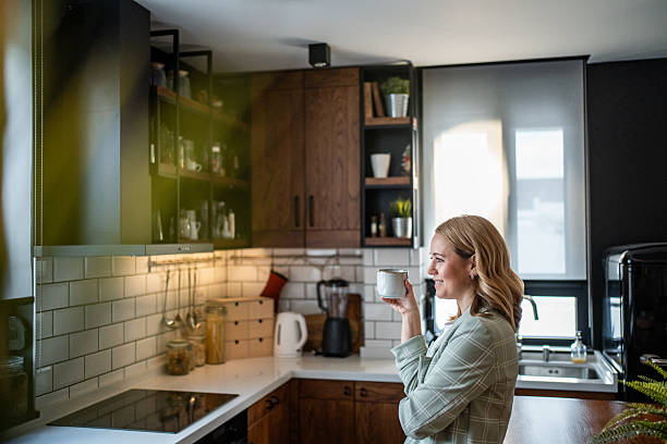 istock Woman enjoying coffee break in modern kitchen 2241649822