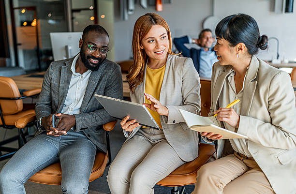 istock Business people collaborating on report during office meeting 2241649840