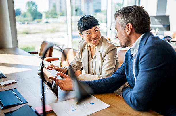 istock Colleagues collaborating on tablet in business meeting 2241651040