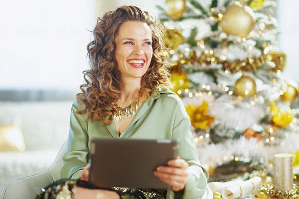 istock Cheerful Woman Connecting on Tablet During Holidays 2241652224